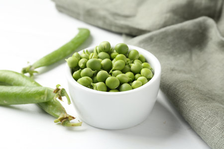 Fresh ripe green peas on white wooden table, closeupの写真素材