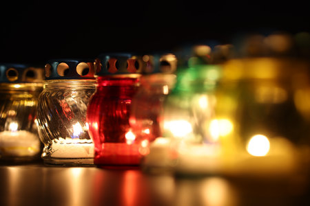 Many grave candles on black background, closeupの写真素材