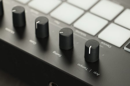 MIDI keyboard with buttons and faders, closeup