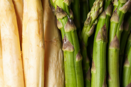 Different raw asparagus spears as background, top viewの写真素材