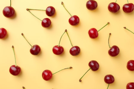 Fresh ripe cherries on beige background, flat layの写真素材