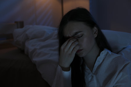 Frustrated woman suffering from insomnia at home, space for textの写真素材