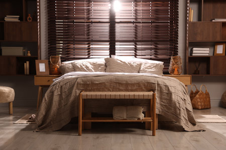 Comfortable bed with beautiful lines in bedroomの写真素材