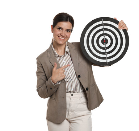 Targeting. Smiling businesswoman pointing at dart board on white backgroundの写真素材