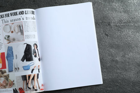 Open magazine on grey table, top view. Mockup for designの写真素材