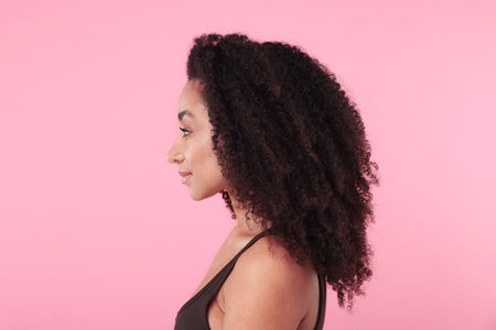 Beautiful Brazilian woman with healthy skin on pink backgroundの写真素材