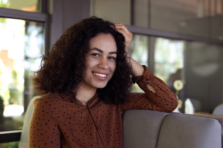 Portrait of smiling Latin American woman in cafe