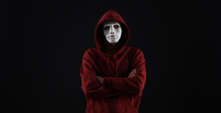 Anonymity. Man wearing mask on dark background