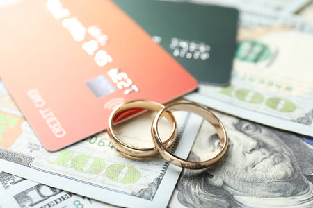 Gold wedding rings, dollar banknotes and credit cards, closeupの写真素材