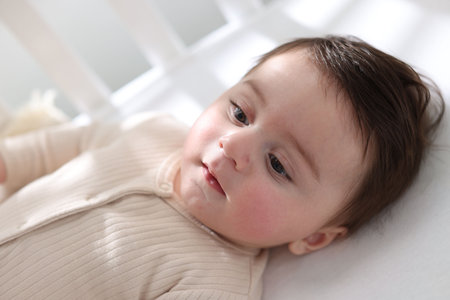Bedtime. Cute little baby in crib at homeの写真素材