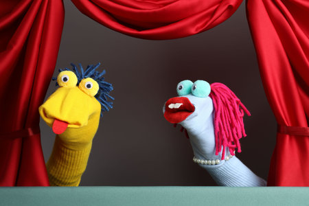 Creative puppet show on stage with red curtainsの写真素材