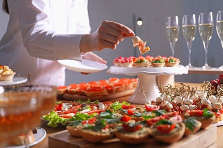 Buffet menu. Woman taking tasty canape from table, closeupの写真素材