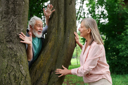 Lovely senior couple near tree in parkの写真素材