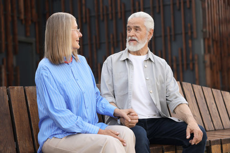 Lovely senior couple on bench near building outdoorsの写真素材