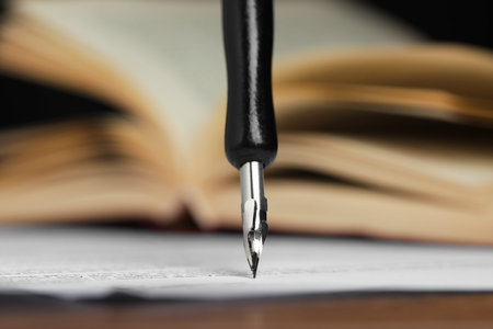 Signing notary document with fountain pen at table, selective focus