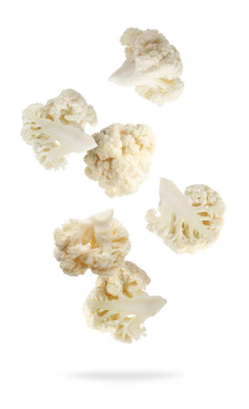 Fresh cauliflower florets falling on white backgroundの写真素材