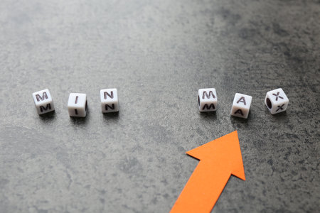 Words Min and Max made of cubes with arrow pointing at it on gray table, closeupの写真素材
