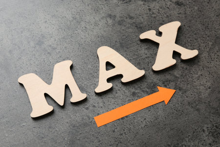 Word Max and arrow on gray table, closeupの写真素材