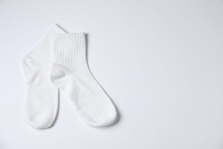 Pair of comfortable socks on white background, top view. Space for textの写真素材