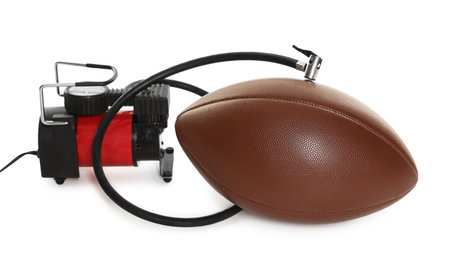 American football ball and air compressor isolated on whiteの写真素材
