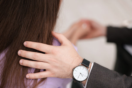 Psychologist supporting patient during therapy session in office, closeup