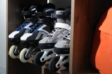 Pairs of roller skates in shelving unit, closeup