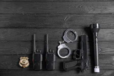 Different police equipment on black wooden table, flat layの写真素材