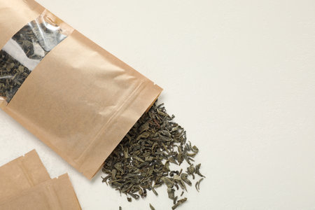 Zipper stand-up pouches and dry leaves on white table, flat lay. Mockup for designの写真素材