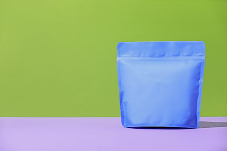 Zipper stand-up pouch on violet table against green background. Mockup for design