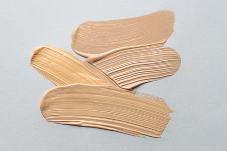 Colorful skin foundations on gray background, flat layの写真素材