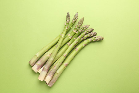 Fresh ripe raw asparagus on green background, top viewの写真素材