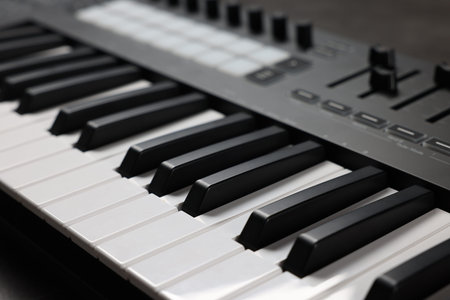 One portable MIDI keyboard on table, closeup