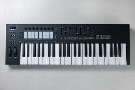 One portable MIDI keyboard on white table, top viewの写真素材