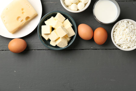 Different dairy products and eggs on gray wooden table, flat lay. Space for textの写真素材