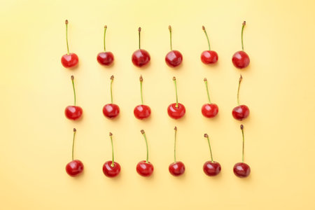 Fresh ripe cherries on beige background, flat lay
