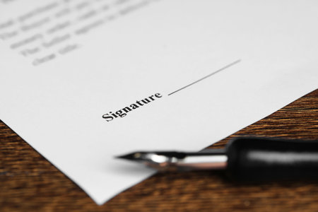Notary document and fountain pen on wooden table, selective focusの写真素材