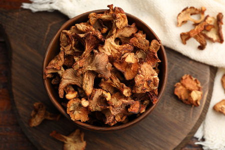 Dried chanterelle mushrooms on wooden table, flat layの写真素材