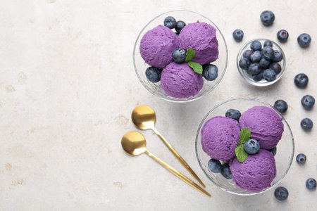 Tasty sorbet with blueberries and mint on light gray table, flat lay. Space for text