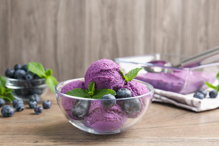 Tasty sorbet with blueberries and mint on wooden table, closeupの写真素材