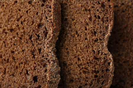 Pieces of fresh rye bread as background, closeup