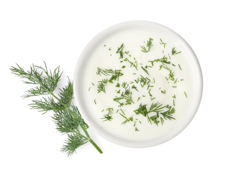 Delicious yogurt in bowl and dill isolated on white, top viewの写真素材