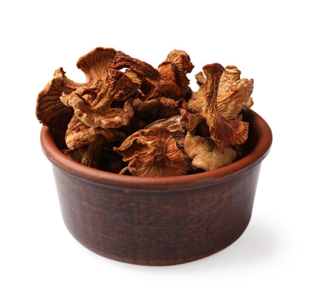 Dried chanterelle mushrooms in bowl isolated on whiteの写真素材