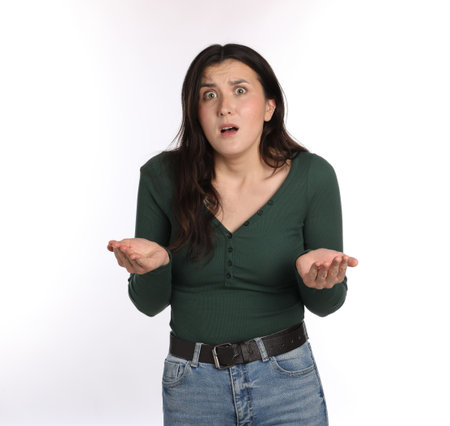 Portrait of confused woman on white background