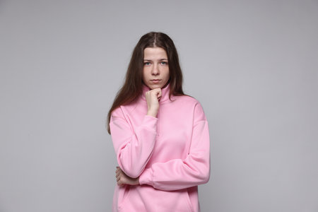 Portrait of teenage girl on light grey backgroundの写真素材