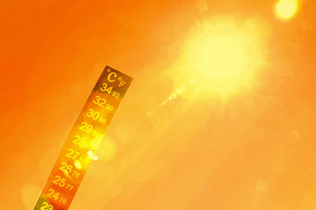Orange sky during hot summer weather. thermometer showing high temperature