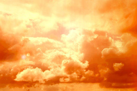 Orange sky with clouds during hot summer weather
