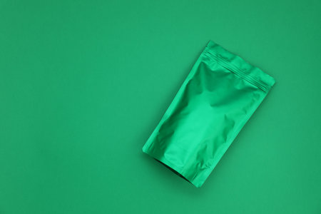 Zipper stand-up pouch on green background. Mockup for design