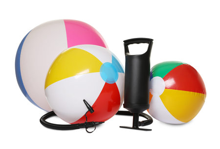 Inflatable balls and manual air pump isolated on white