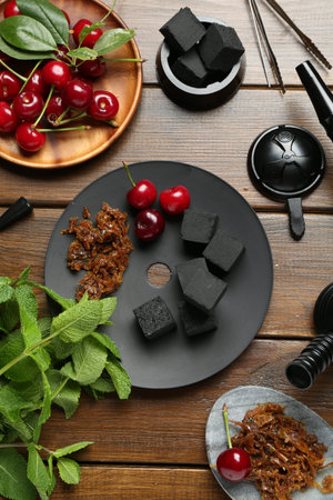 Flat lay composition with traditional hookah parts on wooden table