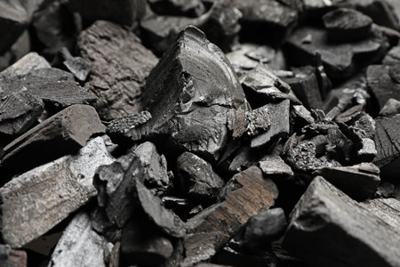 Pieces of black coals as background, closeup